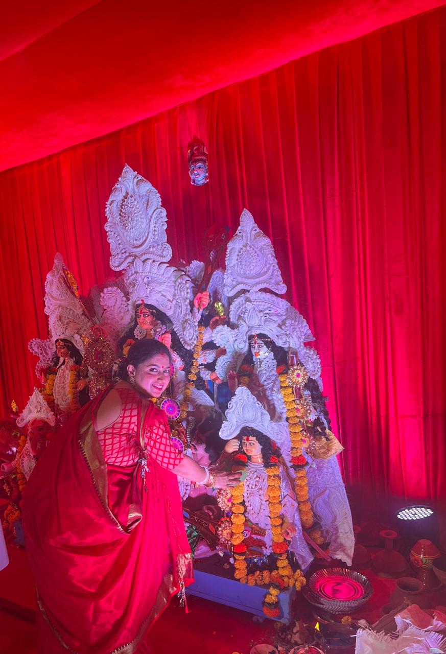 A devotee offering prayers before Maa Durga